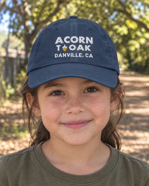 Acorn to Oak, Danville | Embroidered Youth Cap worn by a child in a Danville lifestyle visualization matching the saved supplier design.